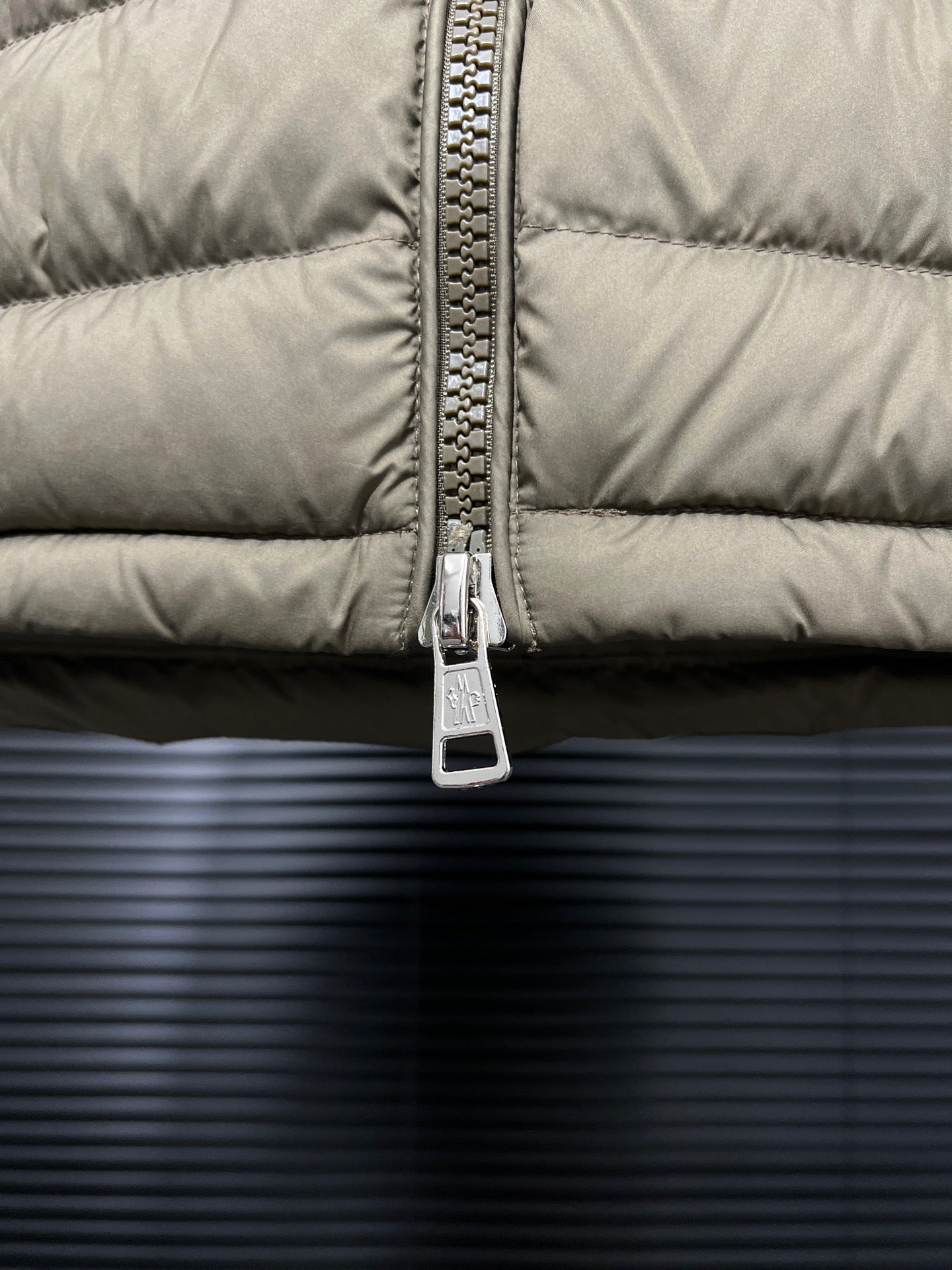 Olive puffer jacket front zipper and metal pull