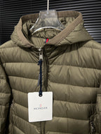 Olive hooded puffer jacket close-up with front zipper and hanging tag
