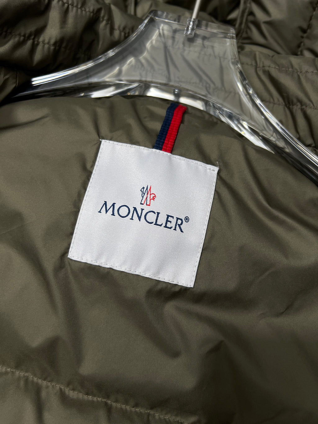 Olive puffer jacket with MONCLER logo tag on inside panel