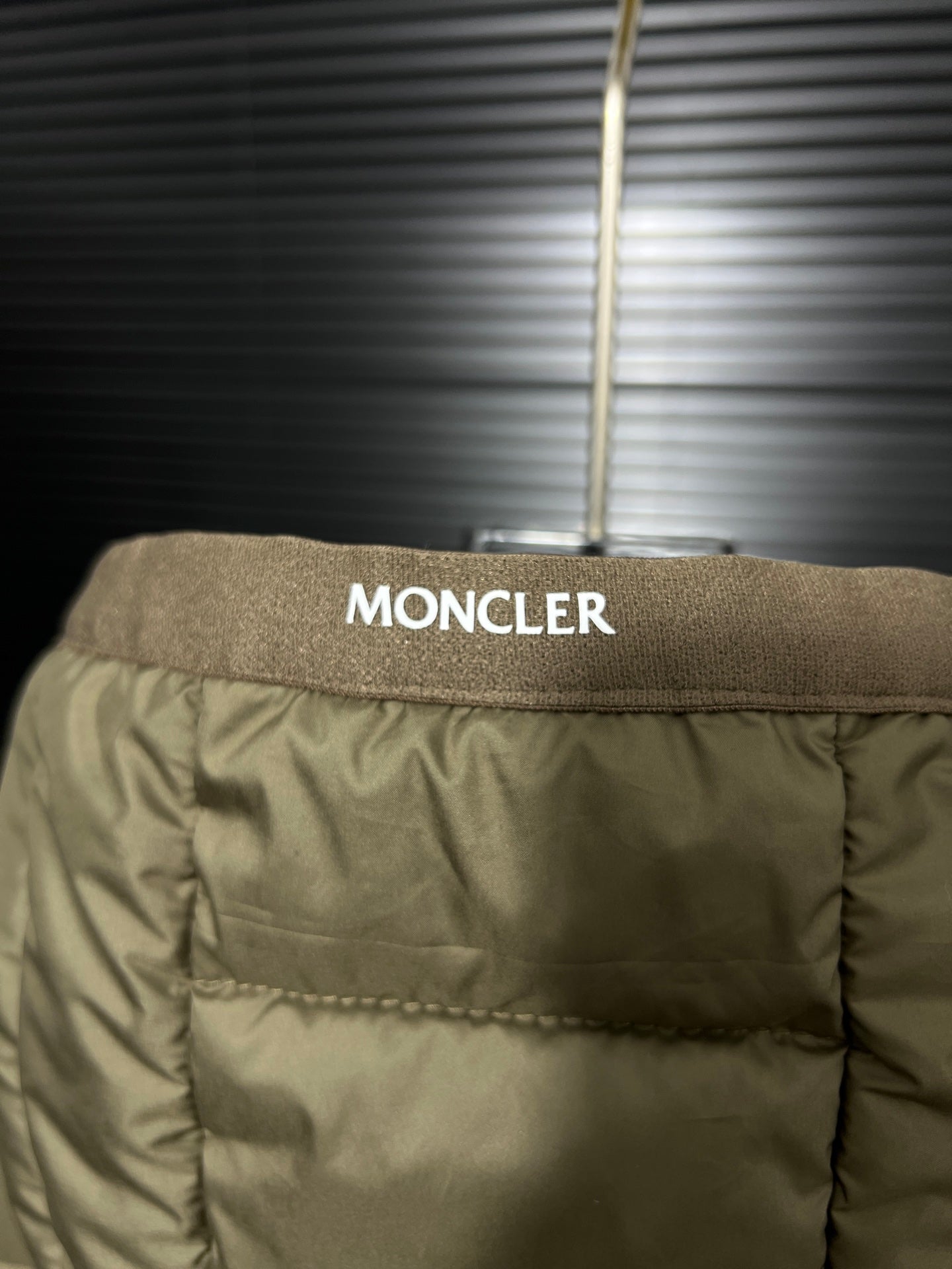 Olive puffer jacket back yoke with MONCLER label