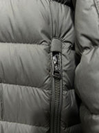 Olive puffer jacket zipper detail with snap trim