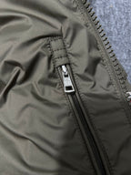 Olive puffer jacket front zipper seam and pull tab