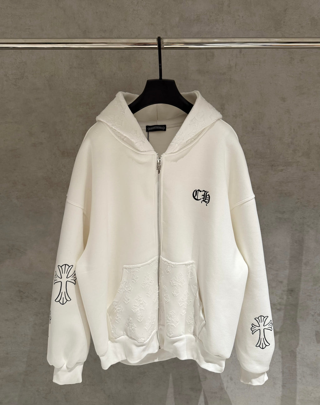 White zip-up hoodie with hood, front zipper pocket, and small chest logo