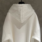 White zip-up hoodie with hood and textured back yoke logo
