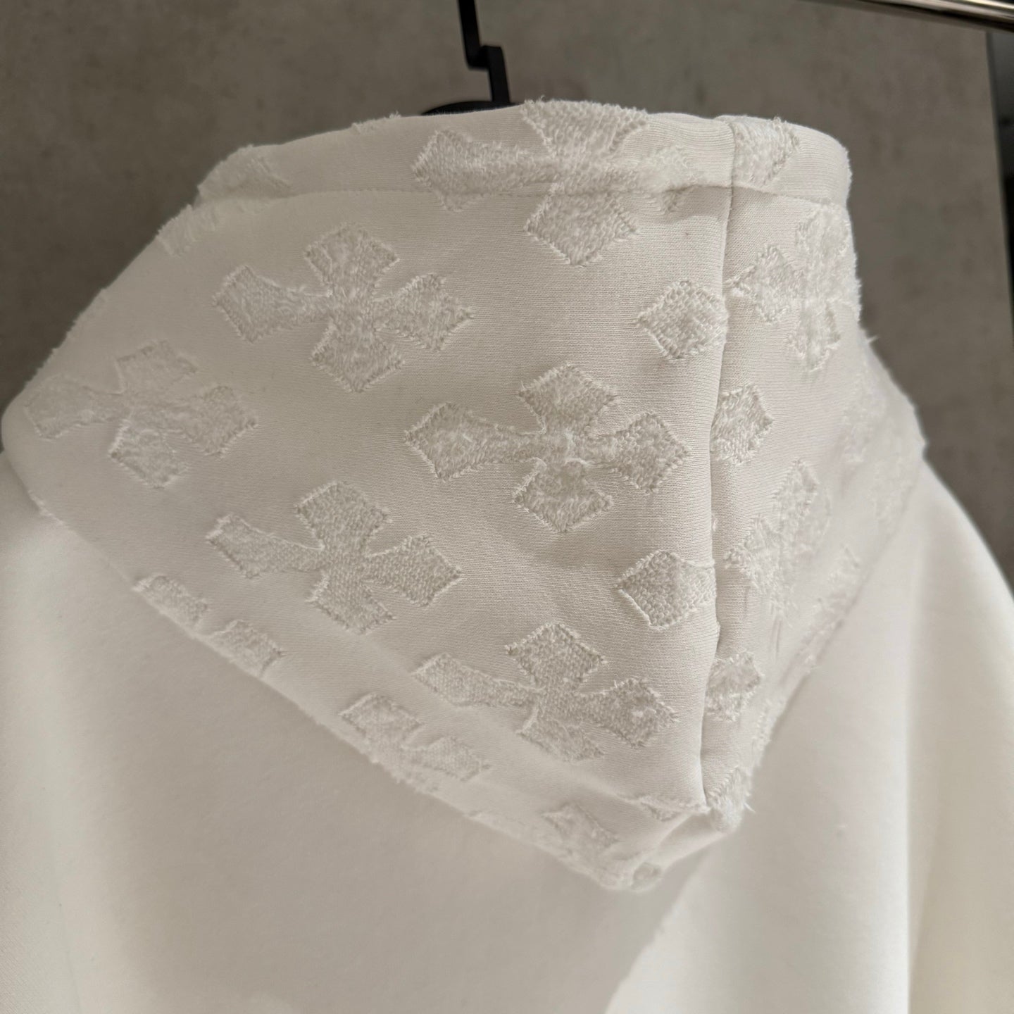 White textured hood with allover patchwork-style pattern