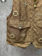 Gold monogram sleeveless vest with flap pockets and round decorative buttons, close-up