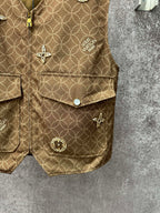 Gold monogram sleeveless vest with flap pockets and round decorative buttons, side view