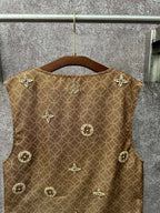 Gold monogram sleeveless vest with decorative medallions, back view on hanger