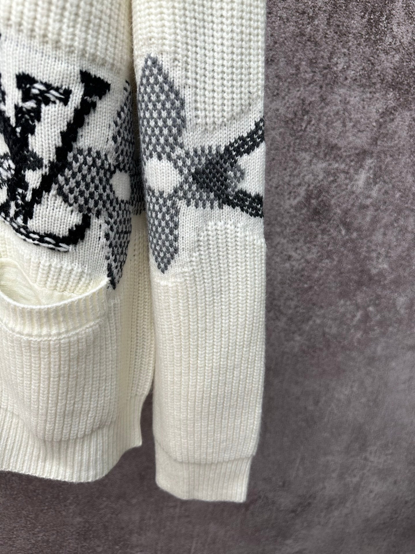 Cream cardigan hem and sleeve with black butterfly-style motif stripe embroidery