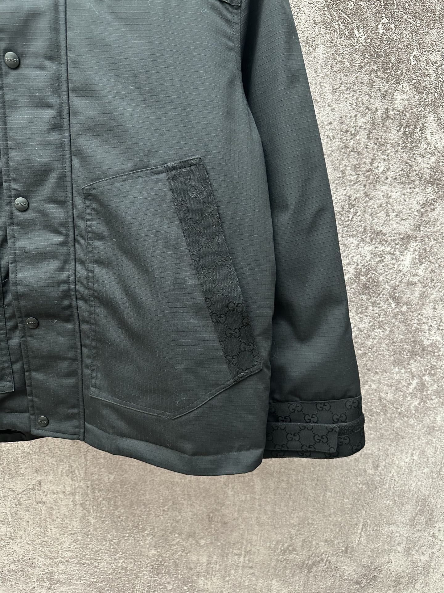 Dark jacket with side pocket and buttoned front placket detail