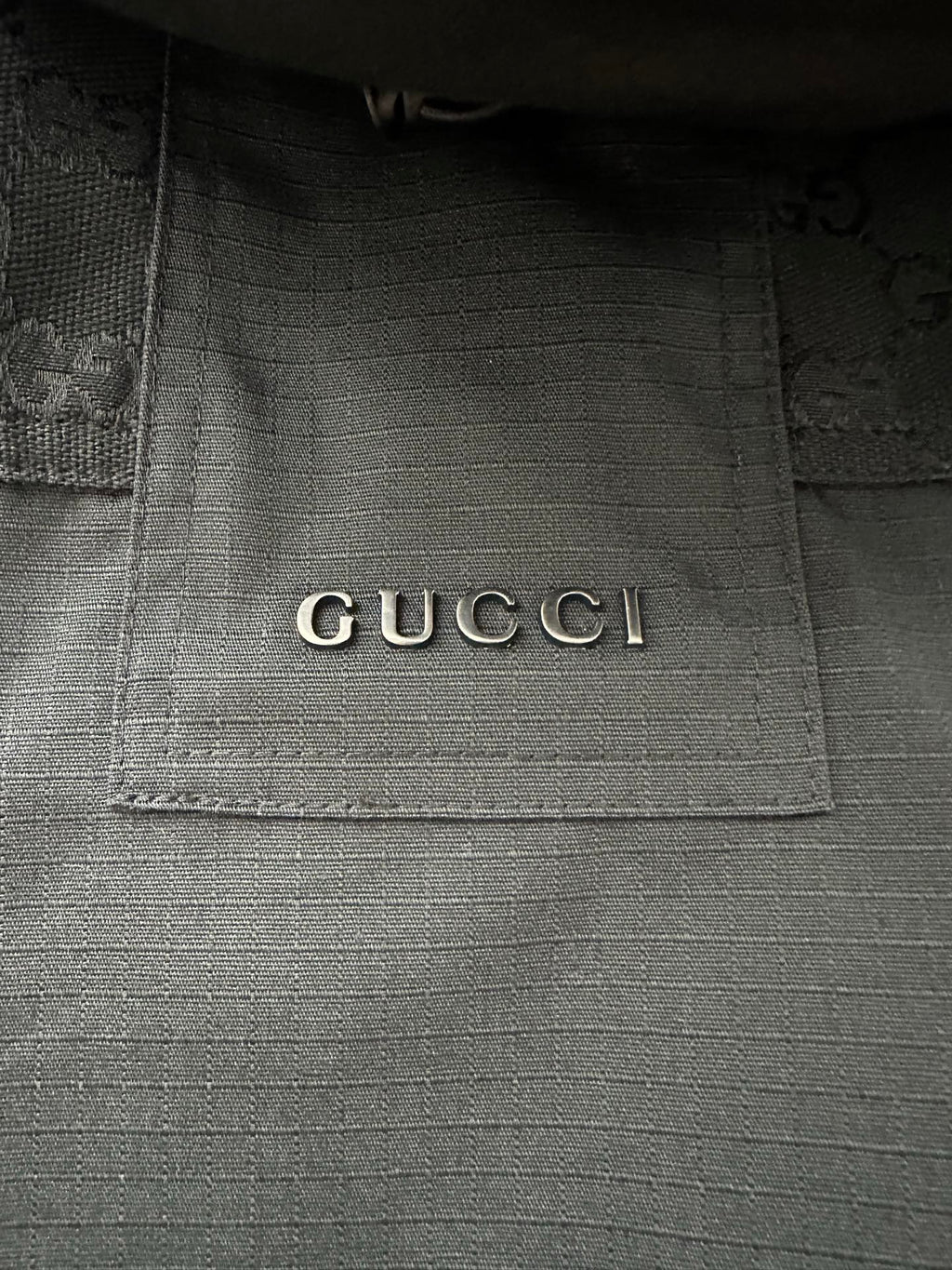 Gucci interior neck label on dark jacket lining