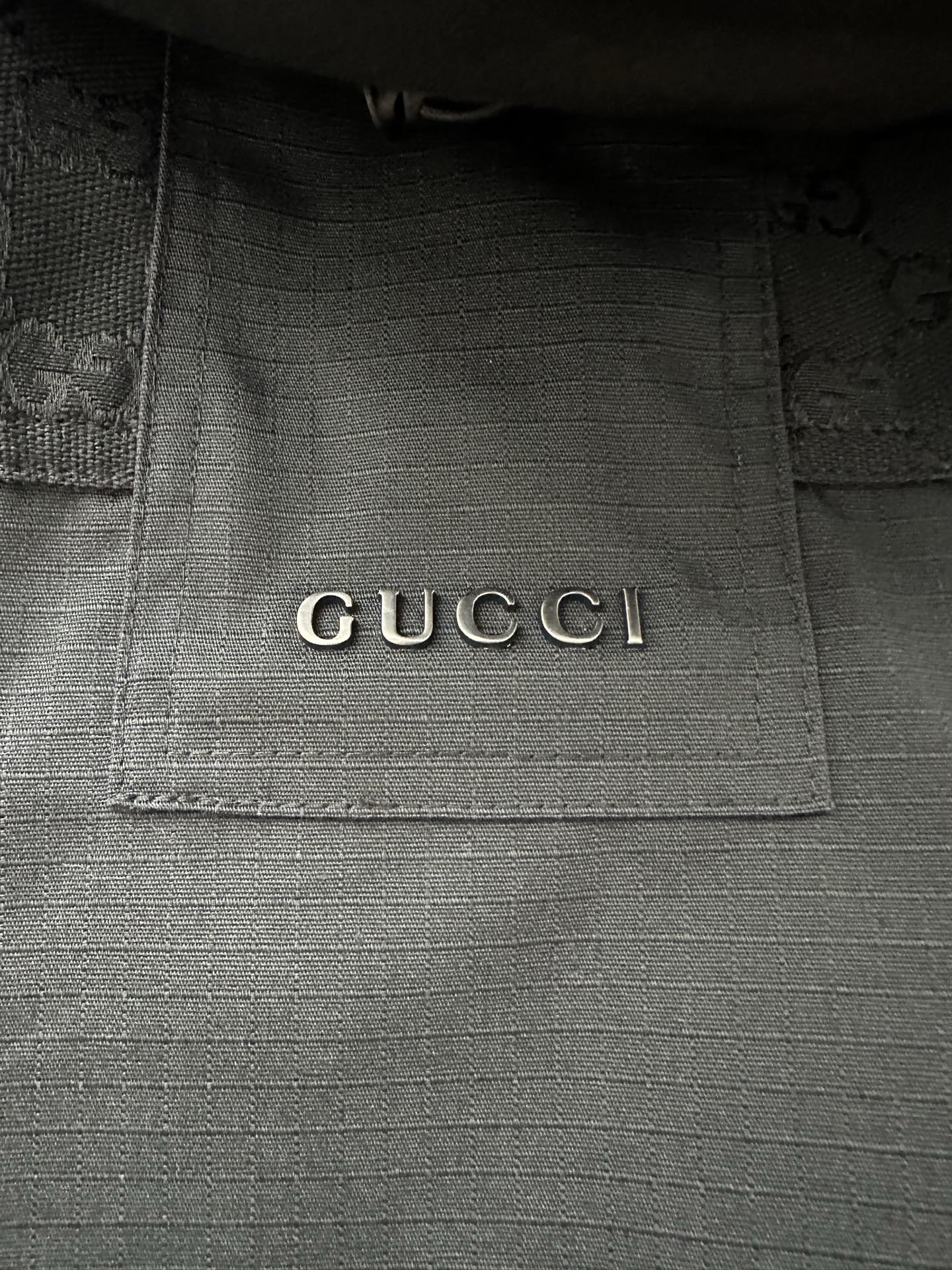 Gucci interior neck label on dark jacket lining
