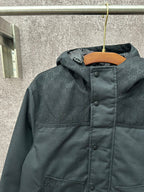 Dark hooded jacket with front panel and buttoned placket