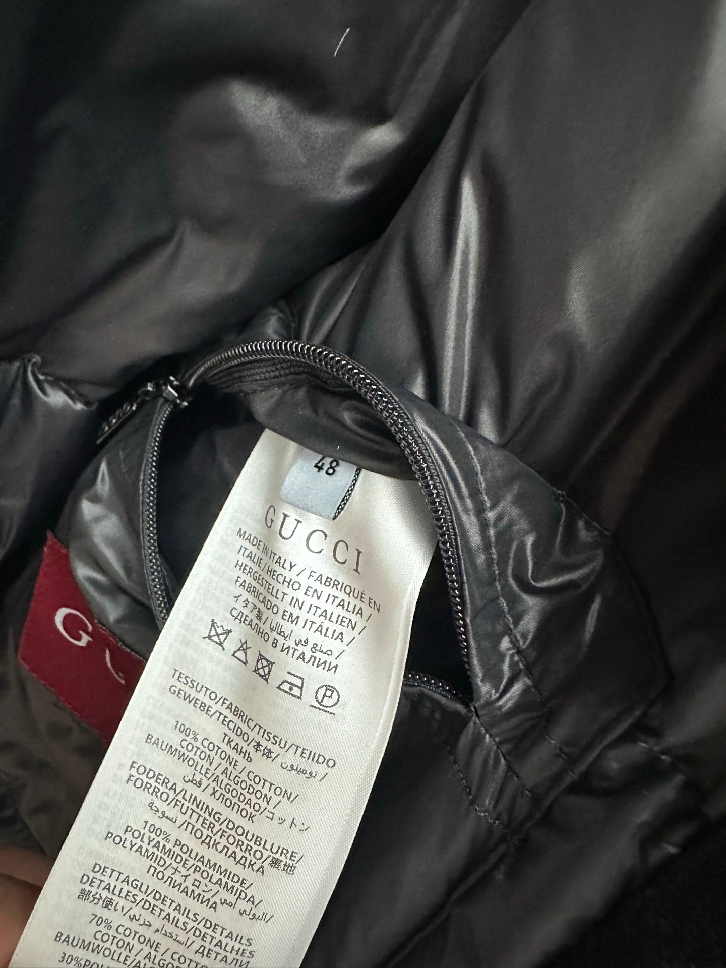 Gucci size 48 care label on dark gray puffer jacket lining