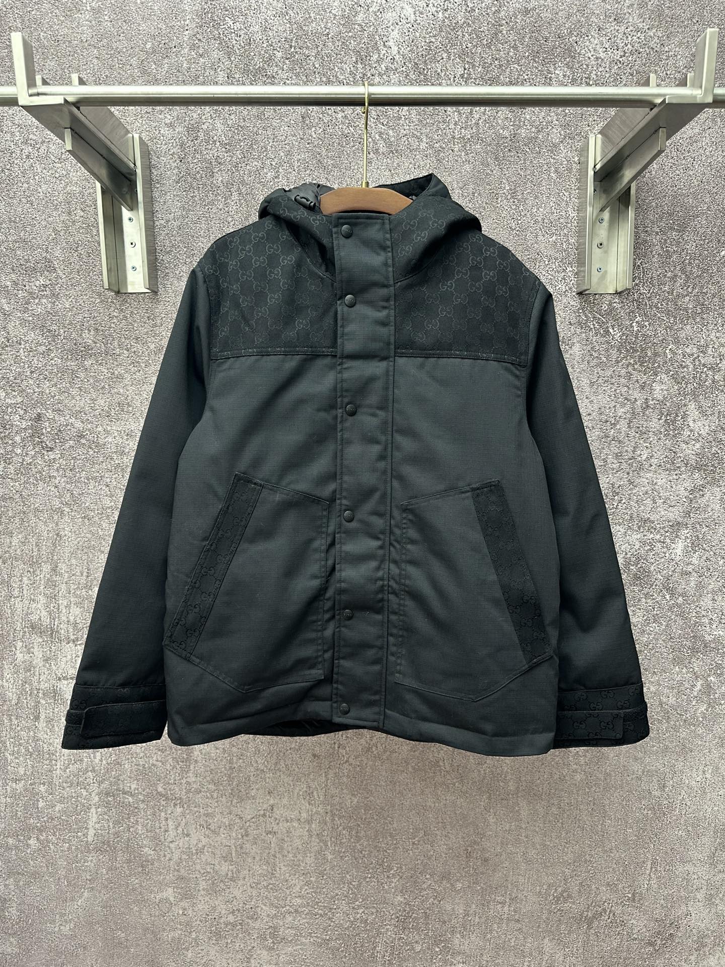 Dark hooded jacket with front button placket and two chest pockets