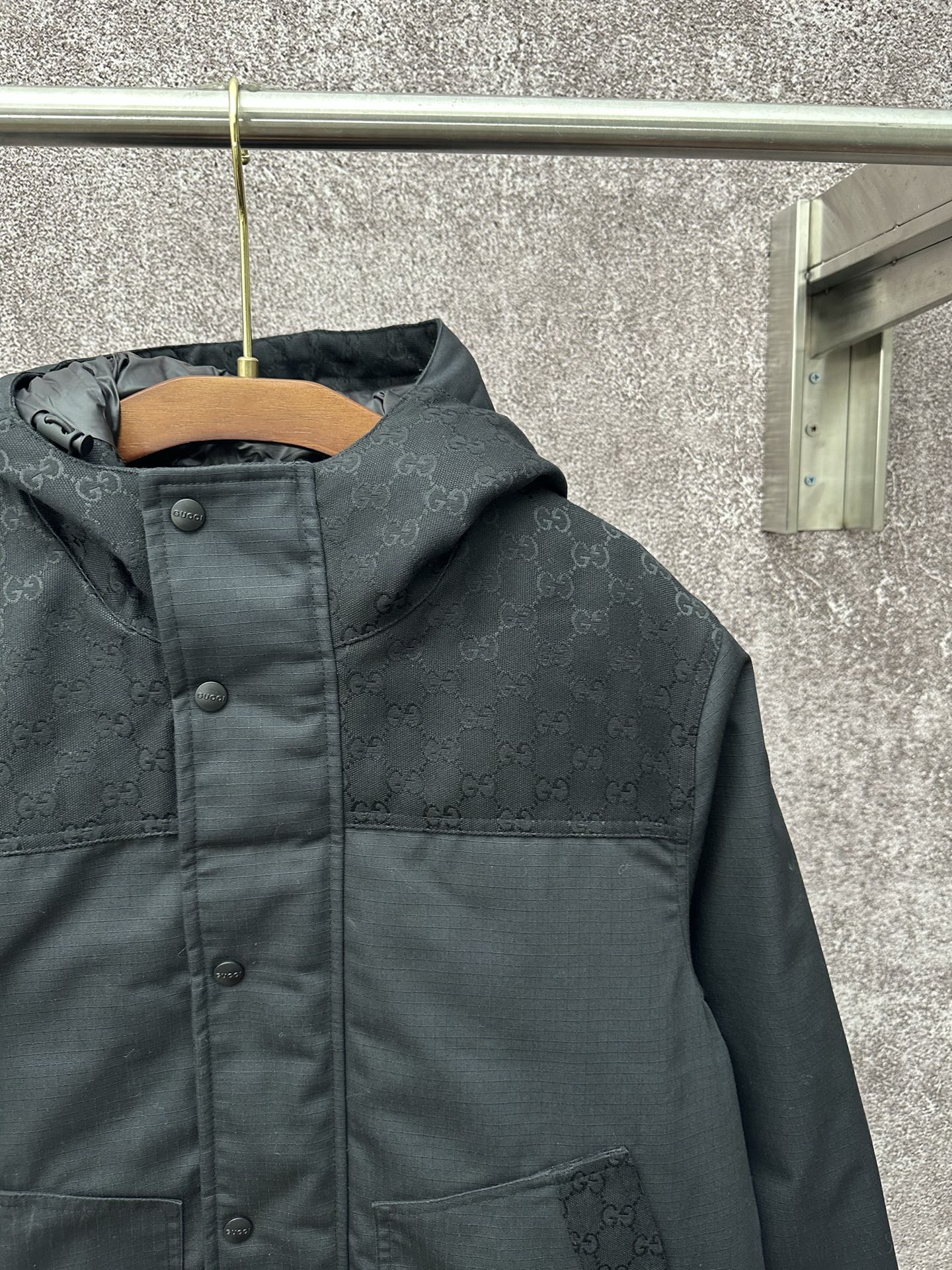Dark hooded jacket with hood and two front pockets