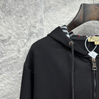 Burberry zip-up hoodie, black, close-up of hood with plaid-lined interior and zipper