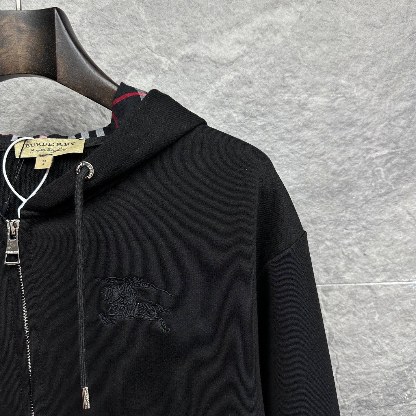 Burberry zip-up hoodie, black, chest area with embossed horse logo and hood details