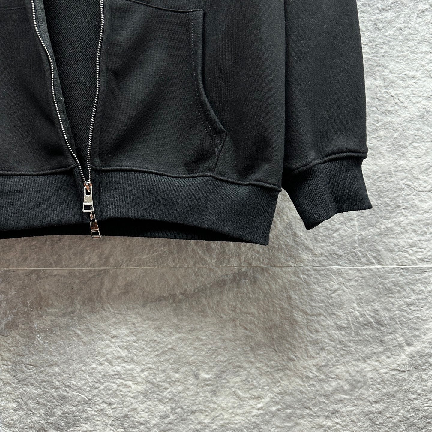Burberry zip-up hoodie, black, close-up of kangaroo pocket and zipper hardware