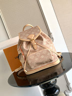 Louis Vuitton monogram mini backpack, tan canvas with leather trim and drawstring.