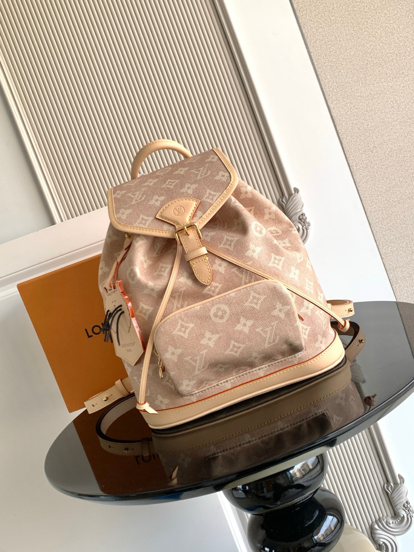 Louis Vuitton monogram mini backpack, tan canvas with leather trim and drawstring.