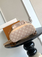 Louis Vuitton monogram mini pouch bag in tan canvas with rounded shape and top handle.
