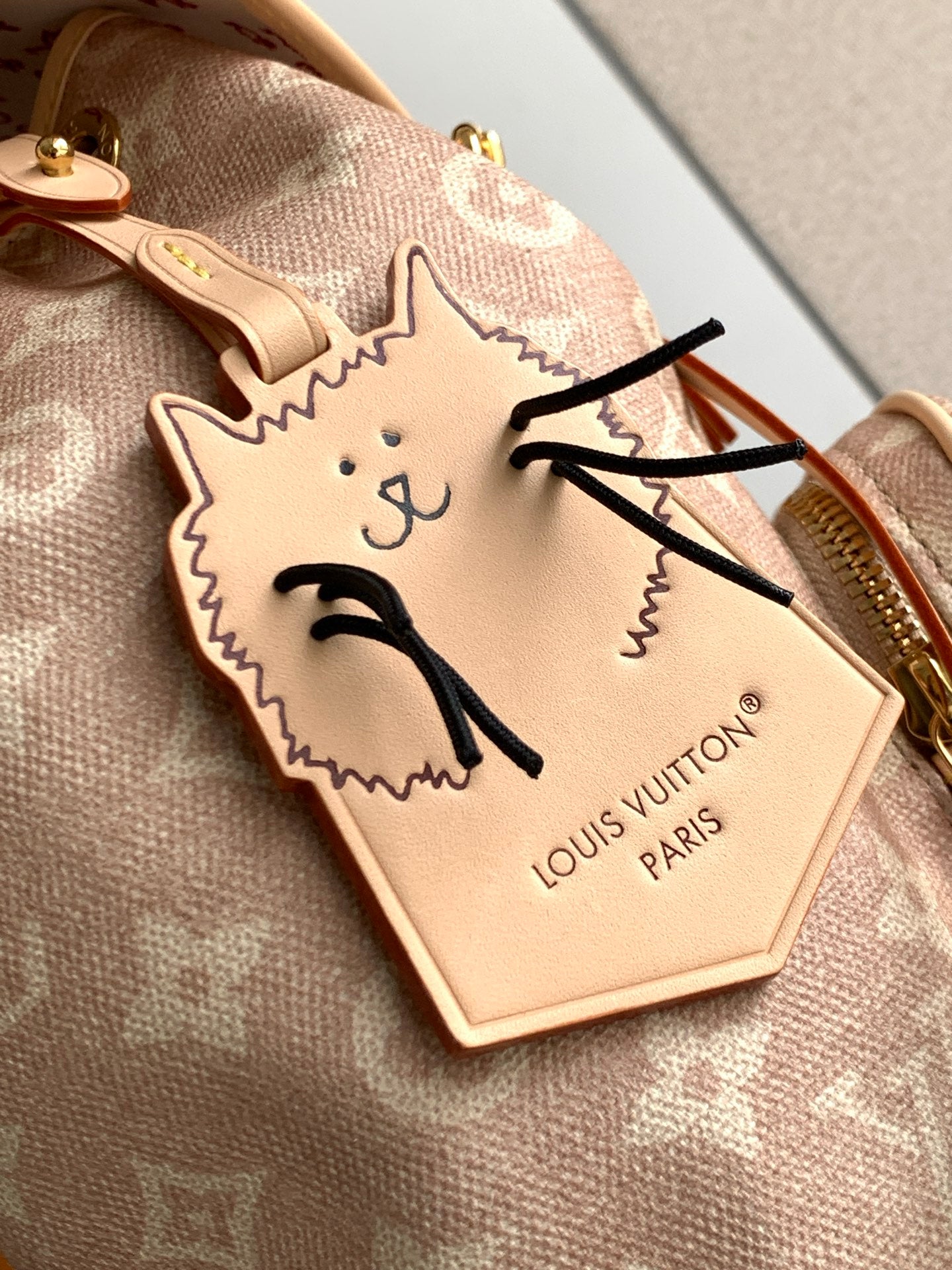 Louis Vuitton cat charm/key holder in cream leather with black embroidered face.