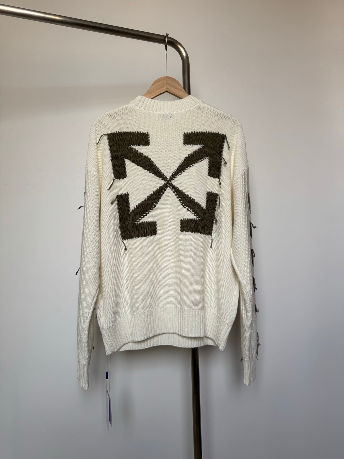 Off-white knit sweater with large black geometric star motif on the back
