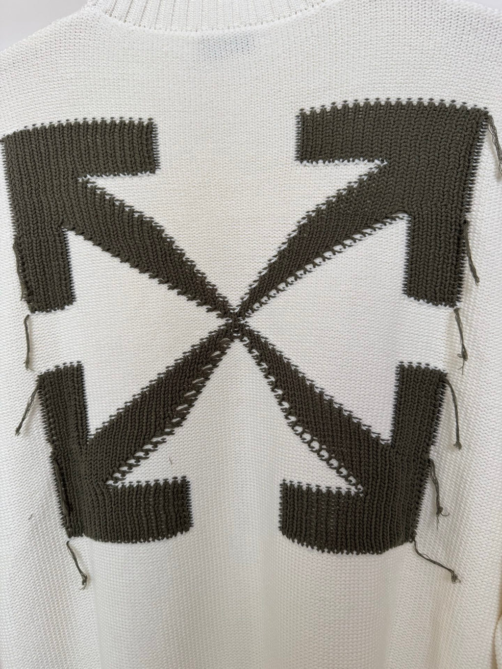 Off-white sweater back close-up with black geometric block and cross motif