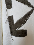Off-white sweater knit with black diagonal stripe and block motif detail