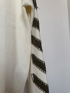 Off-white sweater sleeve with black diagonal stripe-knit detail