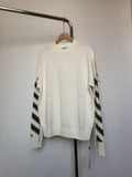 Off-white knit sweater with black striped sleeve patches and ribbed crew neck and cuffs