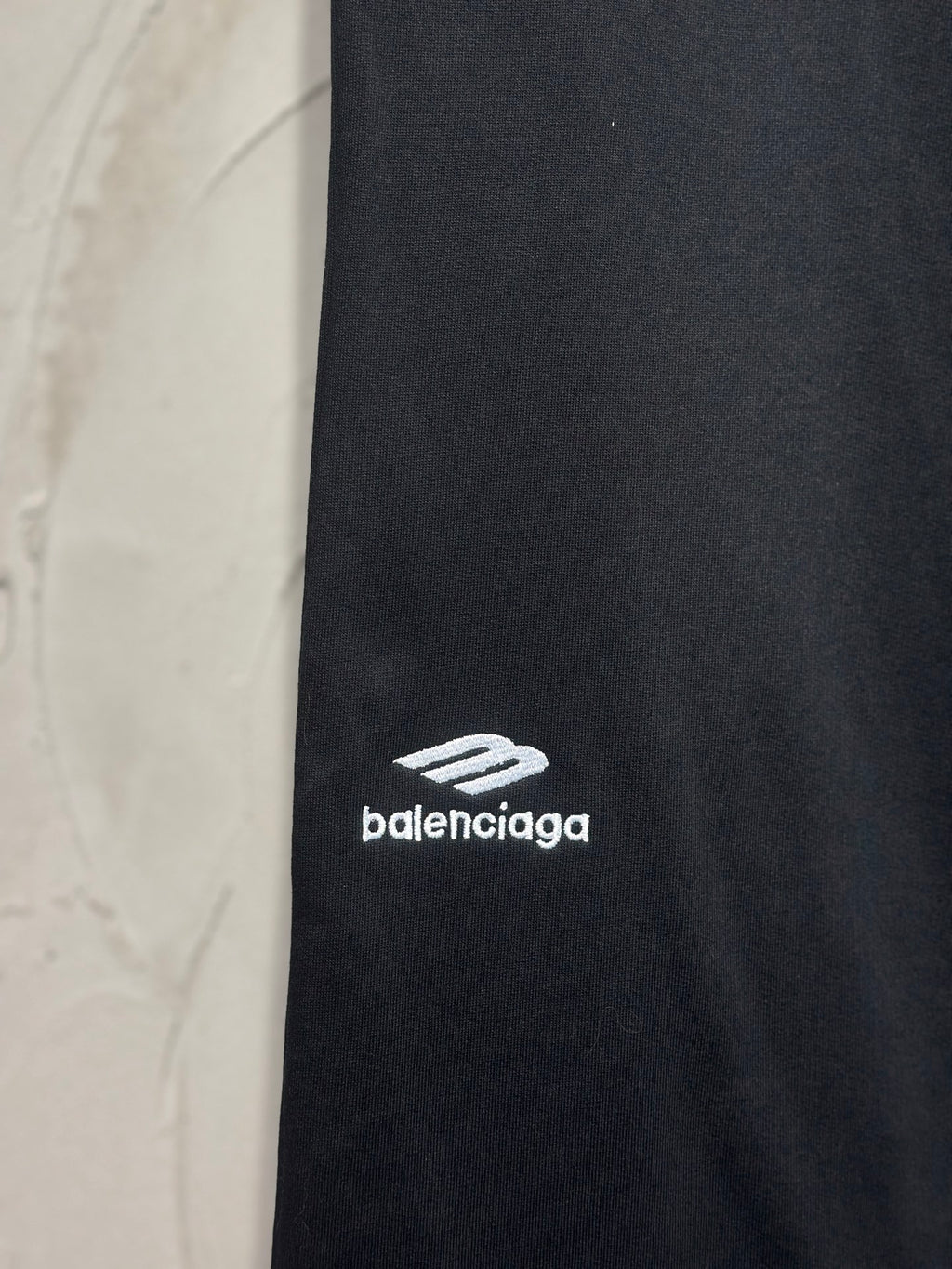 Balenciaga dark black pants with white logo print on side of leg