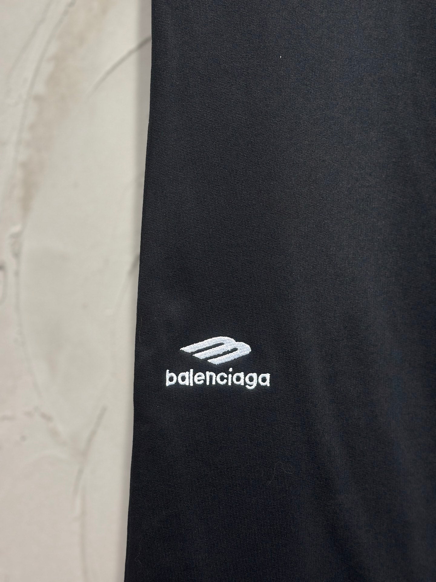 Balenciaga dark black pants with white logo print on side of leg
