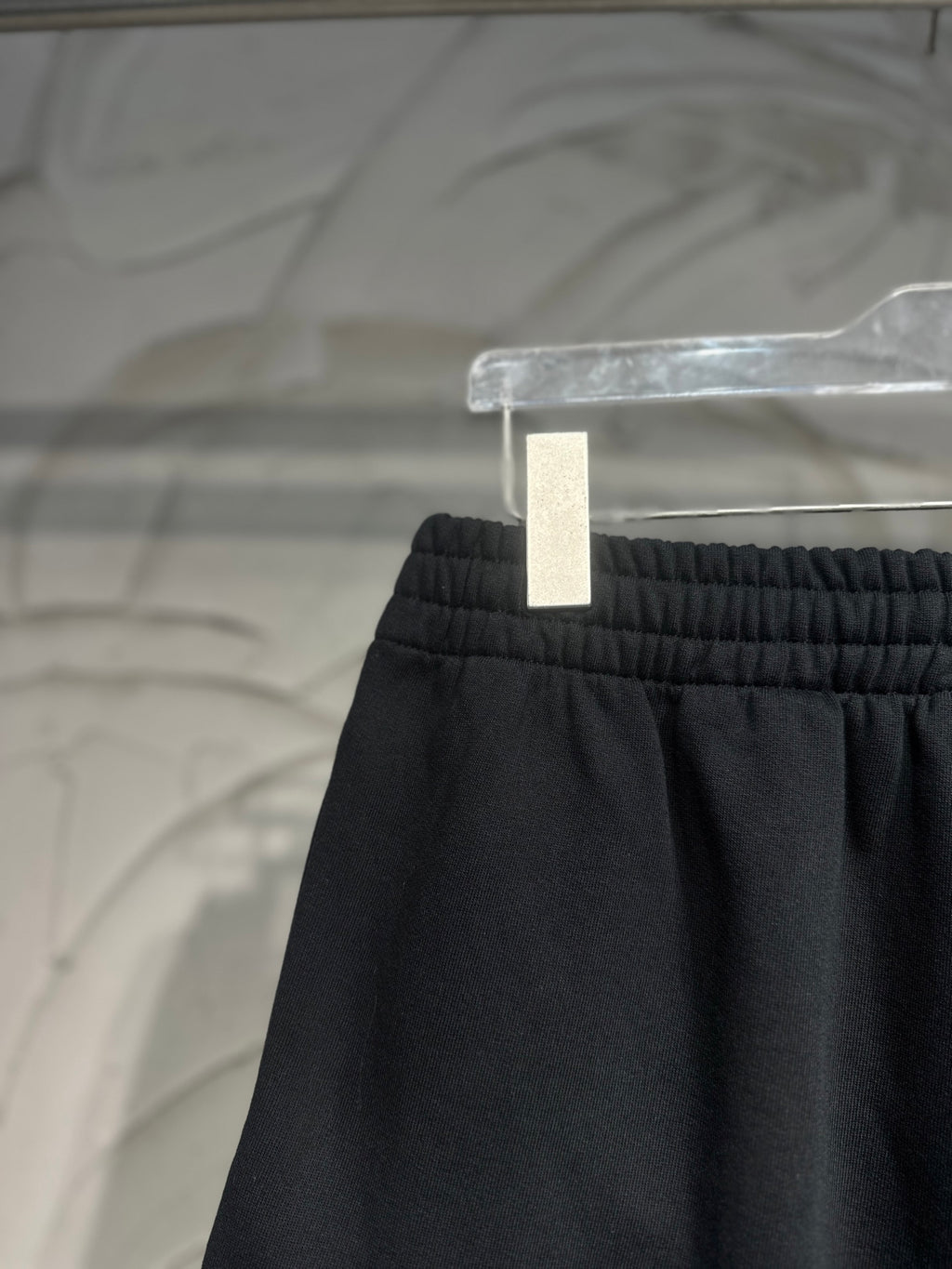 Balenciaga dark black pants waistband close-up with gathered elastic top