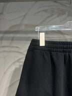 Balenciaga dark black pants waistband close-up with gathered elastic top