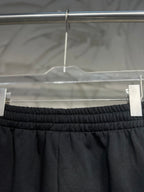 Balenciaga dark black pants waist close-up with elastic band and side panel seams