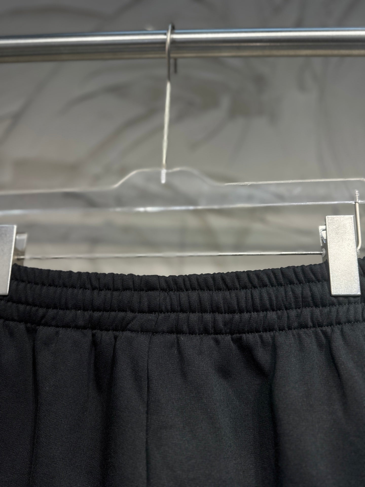 Balenciaga dark black pants waist close-up with elastic band and side panel seams