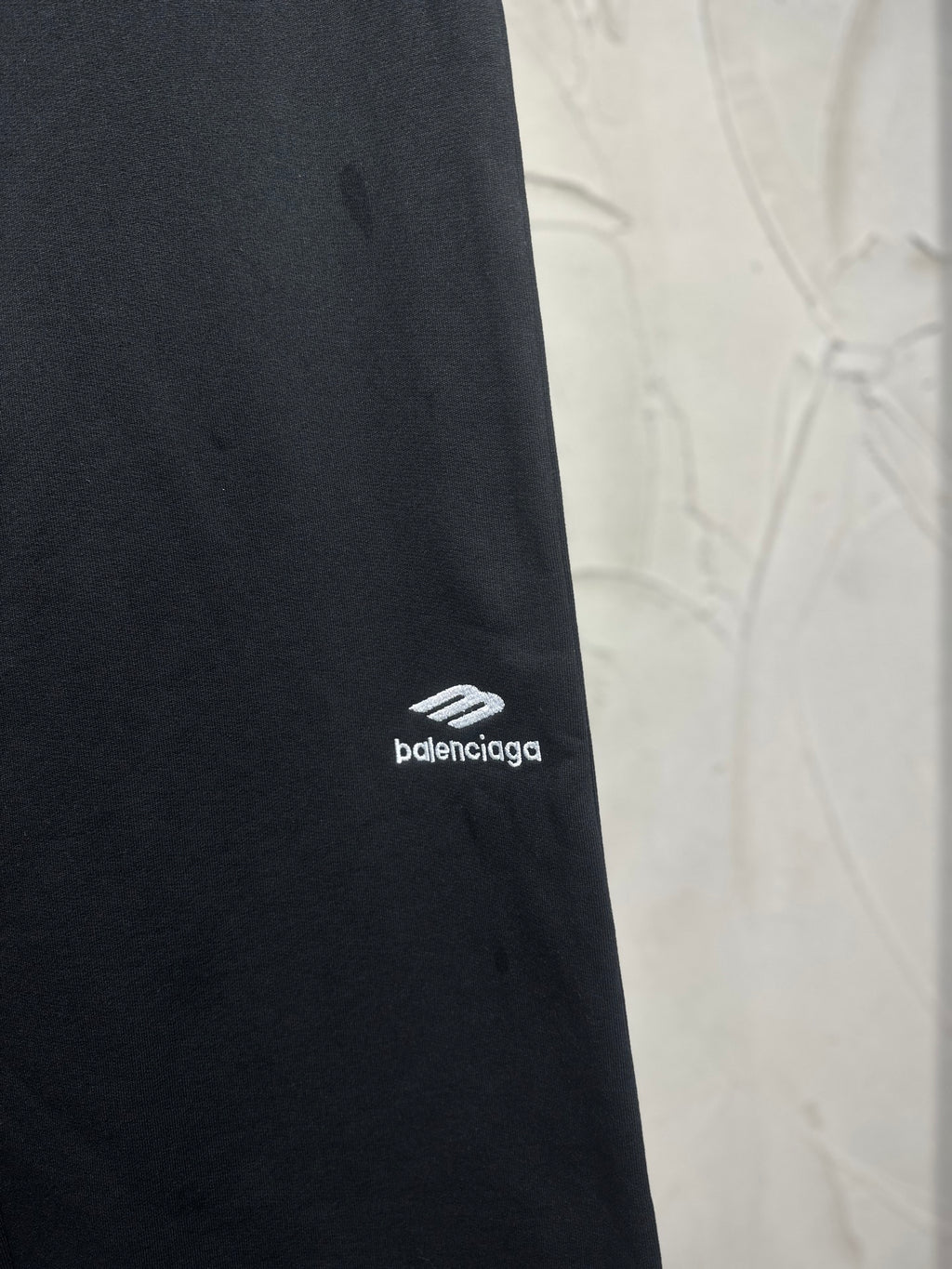 Balenciaga dark black pants with small white logo on the outer leg