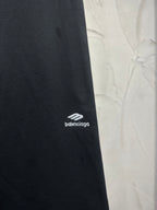 Balenciaga dark black pants with small white logo on the outer leg