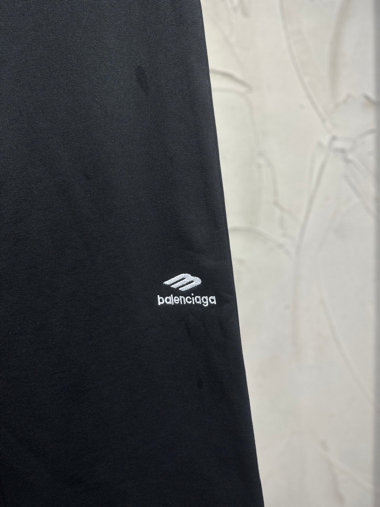 Balenciaga dark black pants with small white logo on the outer leg