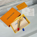 Small bag charm set with silver lipstick pendant, red tip, and metal keyring clasp