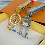 Lipstick-shaped keychains with round clasps, gold and silver bodies on pouch