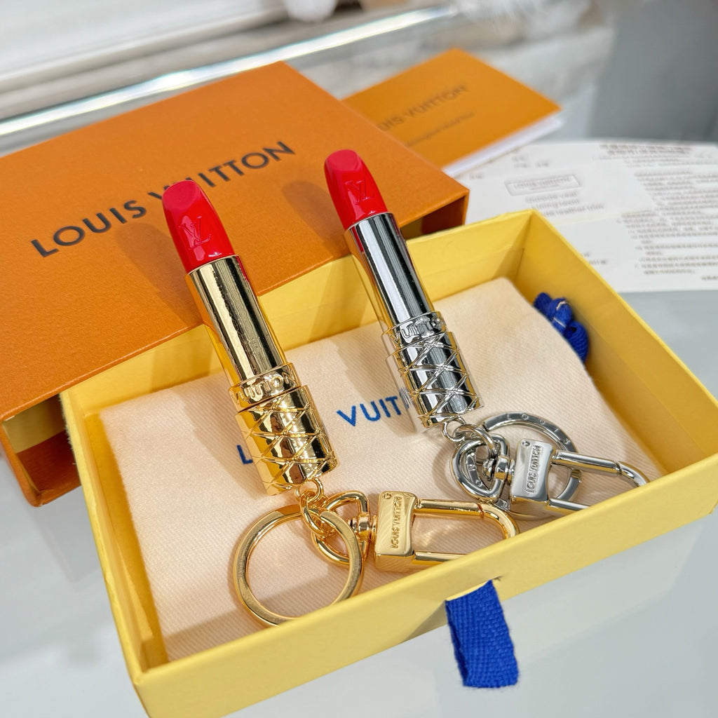 Small bag charm set with two lipstick pendants—gold and silver—plus metal keyring clasps