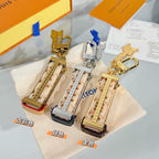 Louis Vuitton mini bag charm keychains on dust bag in silver and gold tones