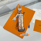 Louis Vuitton keychain with silver lock charm and patterned monogram strap on an orange box