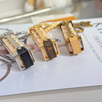 Louis Vuitton mini bag charm keychains in dark, gold, and light strap colors