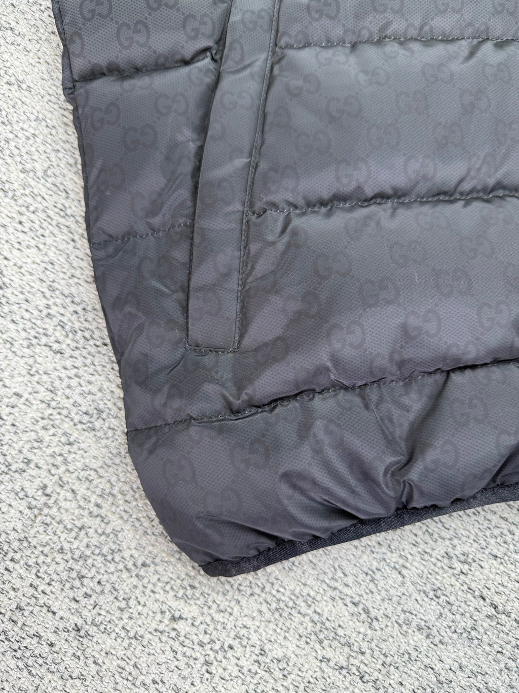 Dark gray puffer jacket with stitched panel seams and zipper placket