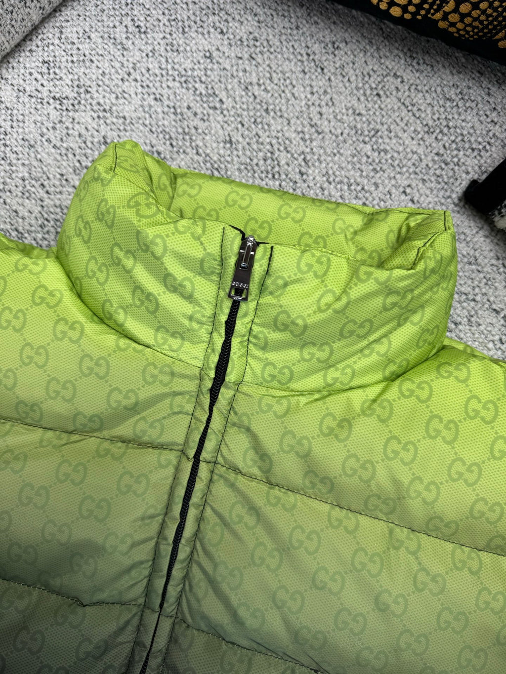 Lime green puffer jacket with black zipper and allover quilted pattern