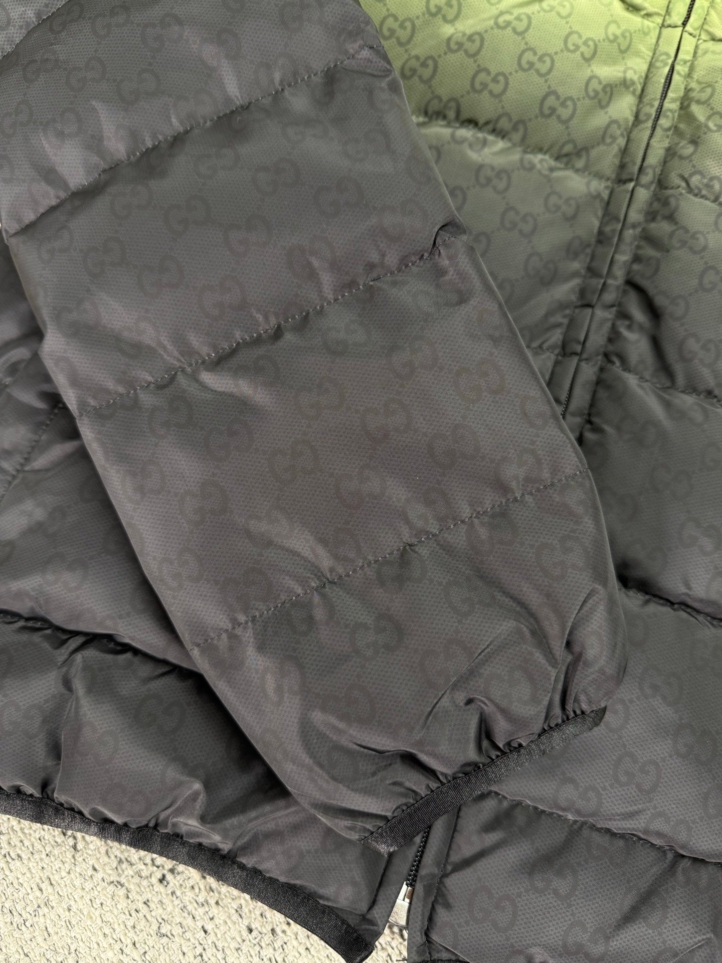 Gray puffer jacket panel with allover GG logo texture and front seam